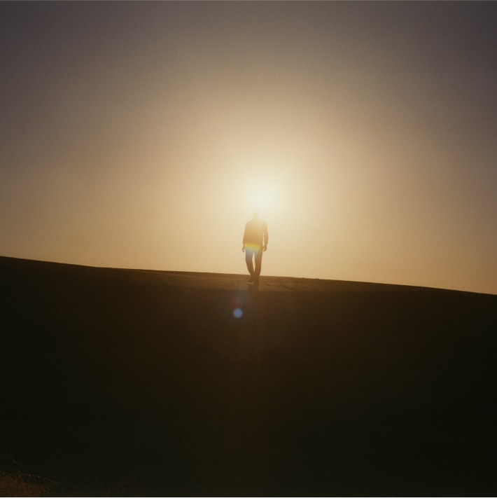 person in front of the sun